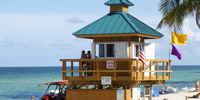Two Ocean Rescue Lifeguard keep an eye on the ocean and beach-goers on a sunny day.
